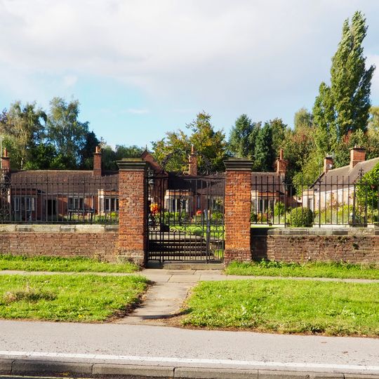 Garden wall and gates approximately 25 metres south east of the John Burrill Homes