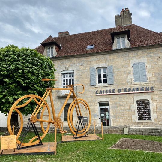 A yellow velo constructed from wood.