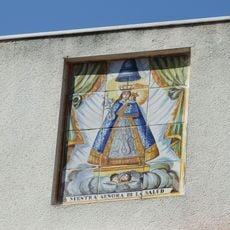 Ceramic panel of Our Lady of Good Health at Joan Carles I street