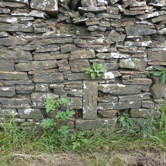 Parish boundary stone in garden wall of Ivy House