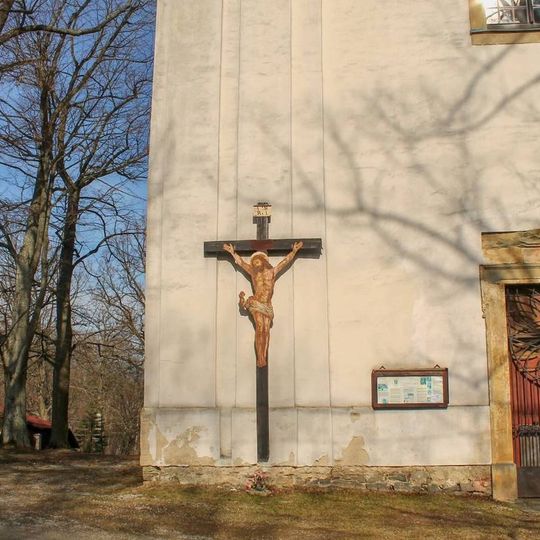 Wooden cross in Vysoké Žibřidovice by the church wall