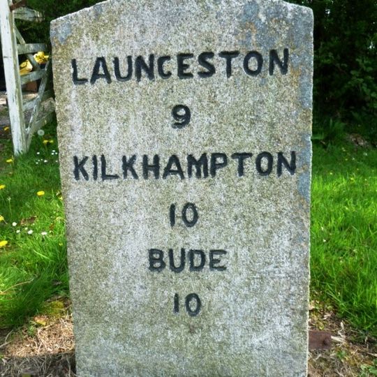 Milestone, in street on wide verge