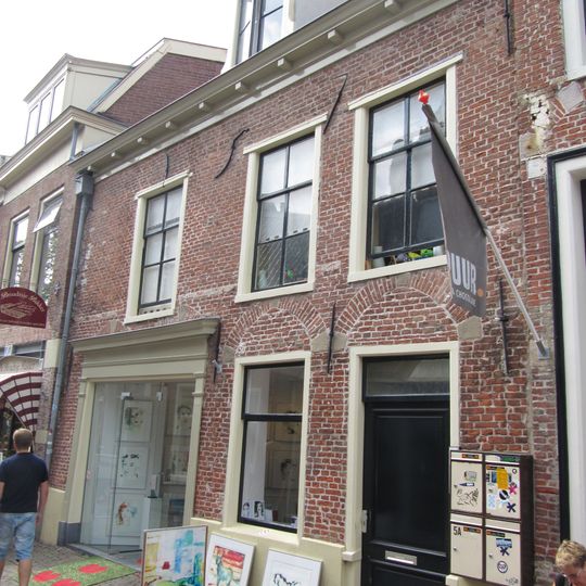 Eenvoudig pand met door ontlastingsbogen overspannen vensters in de beganegrond