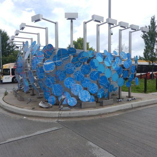 Artwork portrays deconstructed street map of Baltimore. Forms series of panels around bus operator restrooms.