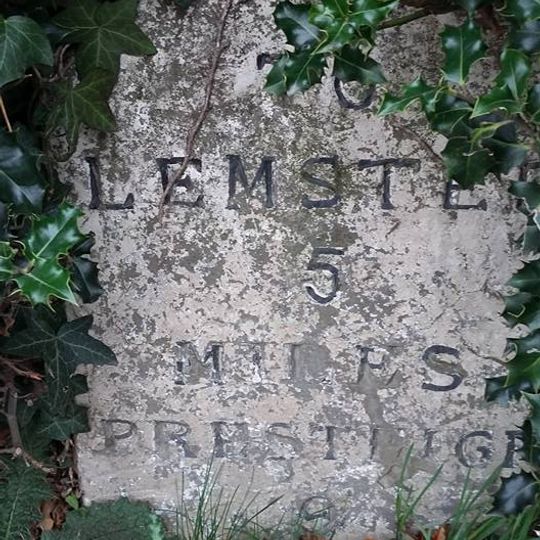 Milestone, near The Monument jct with A4110, in front of Gables Croft