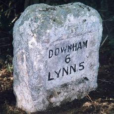 Milestone, trees; front of multi-branched oak