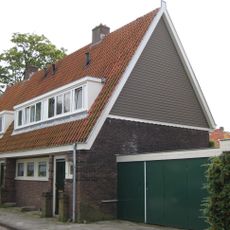 Blok met 4 keukenwoningen, zo genoemd vanwege destijds nieuwe plaatsing van keuken aan de voorzijde, aan de zijkant een houten topgevel, bouwstijl Amsterdamse School.